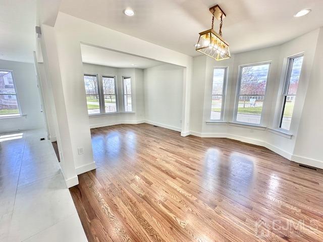 9 Melrose Ave, Sayreville, NJ 08879 - unfurnished dining area with baseboards, wood finished floors, and recessed lighting