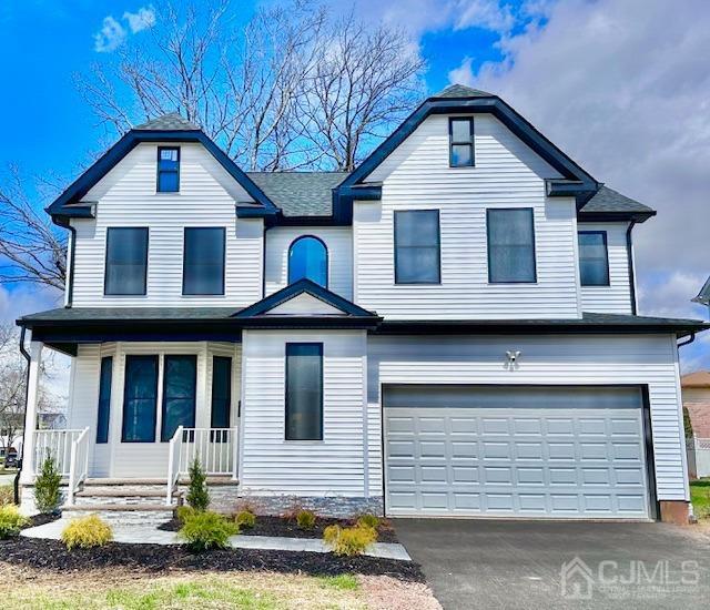 9 Melrose Ave, Sayreville, NJ 08879 - view of front of property with an attached garage, driveway, and covered porch
