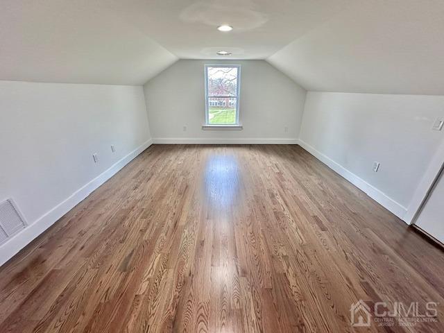 9 Melrose Ave, Sayreville, NJ 08879 - additional living space featuring wood finished floors, visible vents, lofted ceiling, and baseboards