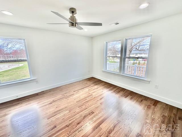 9 Melrose Ave, Sayreville, NJ 08879 - unfurnished room featuring wood finished floors, a wealth of natural light, a ceiling fan, and baseboards