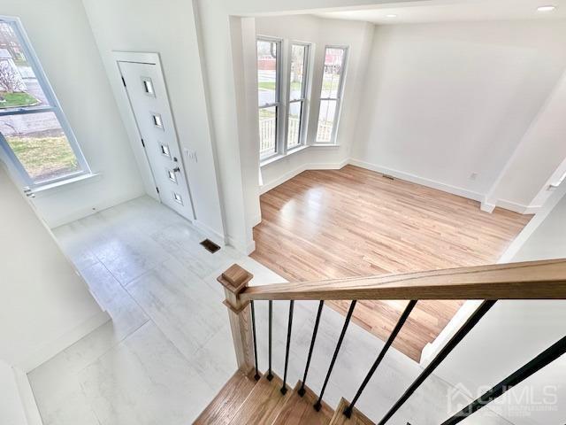 9 Melrose Ave, Sayreville, NJ 08879 - entrance foyer featuring baseboards, wood finished floors, and a healthy amount of sunlight