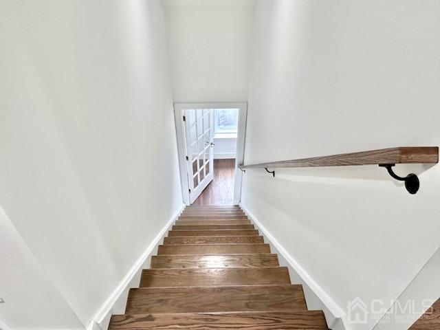 9 Melrose Ave, Sayreville, NJ 08879 - staircase featuring baseboards, wood finished floors, and a high ceiling