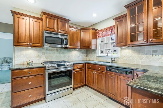 318 Ambrose Ave, Middlesex, NJ 08846 - kitchen featuring appliances with stainless steel finishes, dark stone counters, glass insert cabinets, light tile patterned flooring, and recessed lighting