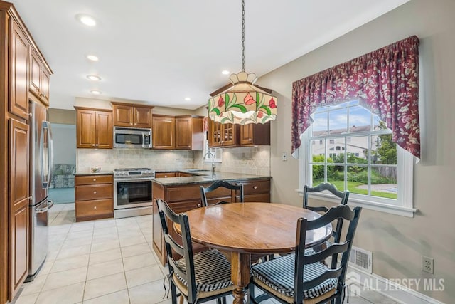 318 Ambrose Ave, Middlesex, NJ 08846 - kitchen with appliances with stainless steel finishes, backsplash, brown cabinets, light tile patterned flooring, and recessed lighting