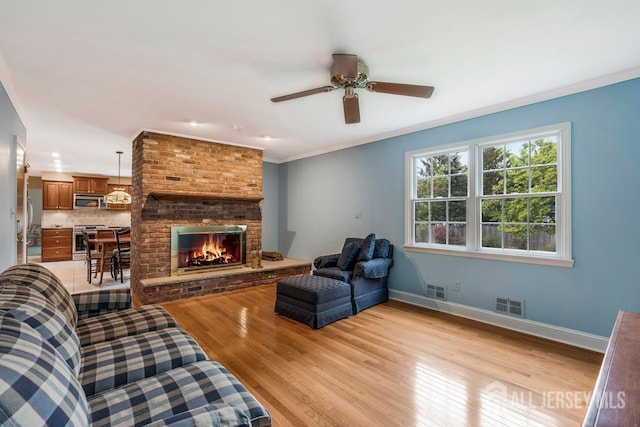 318 Ambrose Ave, Middlesex, NJ 08846 - living area featuring light wood finished floors, ceiling fan, a fireplace, and crown molding