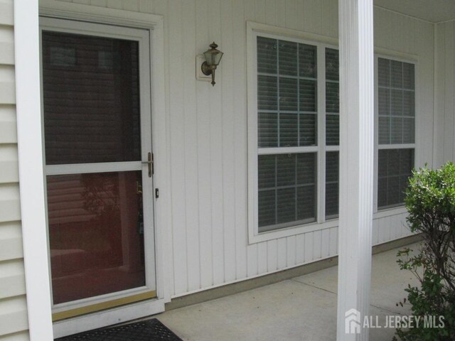 view of exterior entry featuring a porch