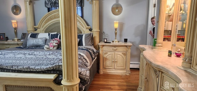 95 Gravel Hill-Spotswood Rd, Monroe, NJ 08831 - bedroom with wood finished floors, a baseboard heating unit, and ornate columns
