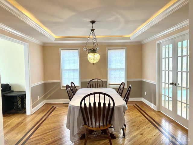 150 Montrose Ave, South Plainfield, NJ 07080 - dining room with a raised ceiling, plenty of natural light, light wood finished floors, ornamental molding, and french doors