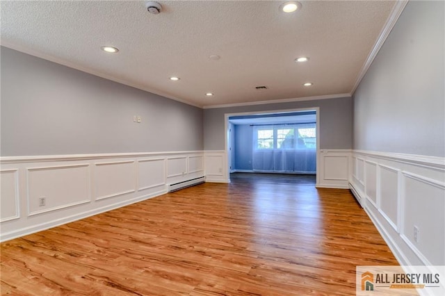73 Chatham Dr Unit 73A, Monroe, NJ 08831 - spare room featuring ornamental molding, a decorative wall, a baseboard heating unit, a textured ceiling, and recessed lighting