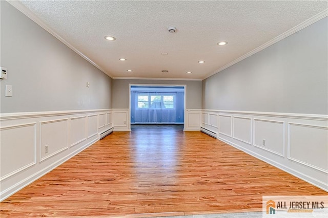 73 Chatham Dr Unit 73A, Monroe, NJ 08831 - empty room featuring ornamental molding, light wood finished floors, recessed lighting, a textured ceiling, and baseboard heating