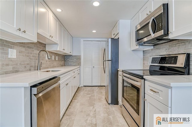 73 Chatham Dr Unit 73A, Monroe, NJ 08831 - kitchen with appliances with stainless steel finishes, a sink, decorative backsplash, white cabinets, and recessed lighting
