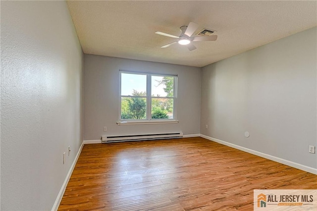 73 Chatham Dr Unit 73A, Monroe, NJ 08831 - unfurnished room with baseboard heating, wood finished floors, a ceiling fan, and a textured ceiling