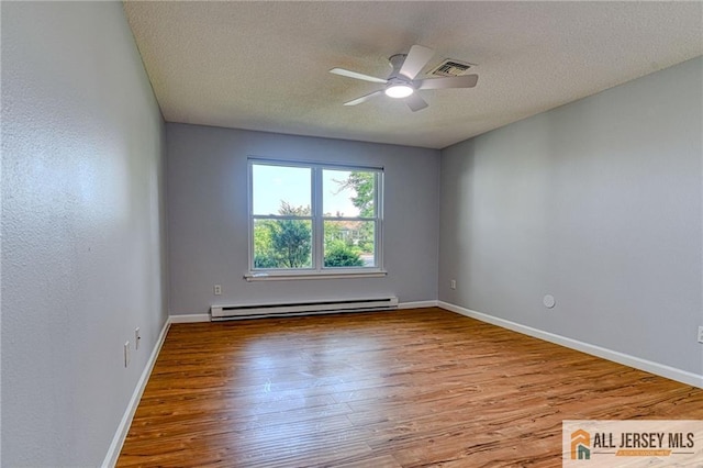 73 Chatham Dr Unit 73A, Monroe, NJ 08831 - empty room with a baseboard radiator, wood finished floors, ceiling fan, a textured ceiling, and baseboards