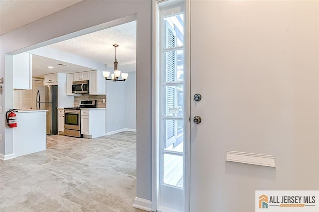 73 Chatham Dr Unit 73A, Monroe, NJ 08831 - entrance foyer with a chandelier and baseboards