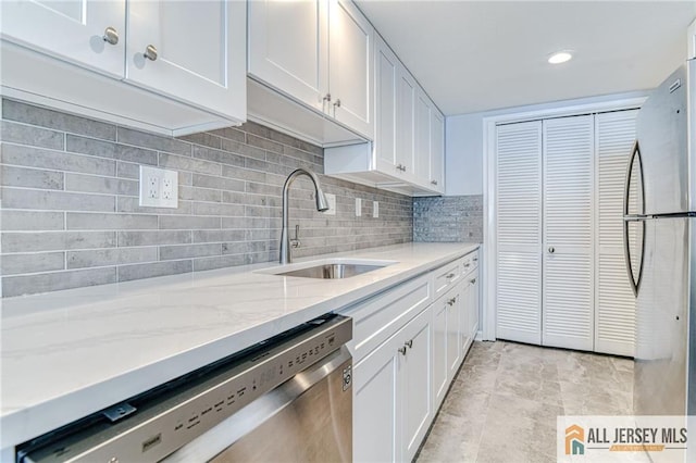 73 Chatham Dr Unit 73A, Monroe, NJ 08831 - kitchen with stainless steel appliances, a sink, white cabinetry, light stone countertops, and backsplash