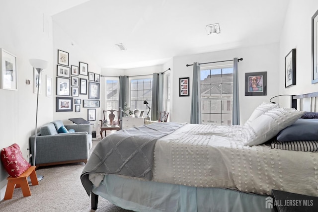 bedroom featuring carpet and vaulted ceiling