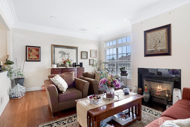 living room with light hardwood / wood-style flooring and ornamental molding