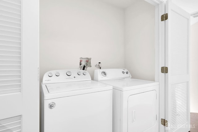 clothes washing area featuring independent washer and dryer