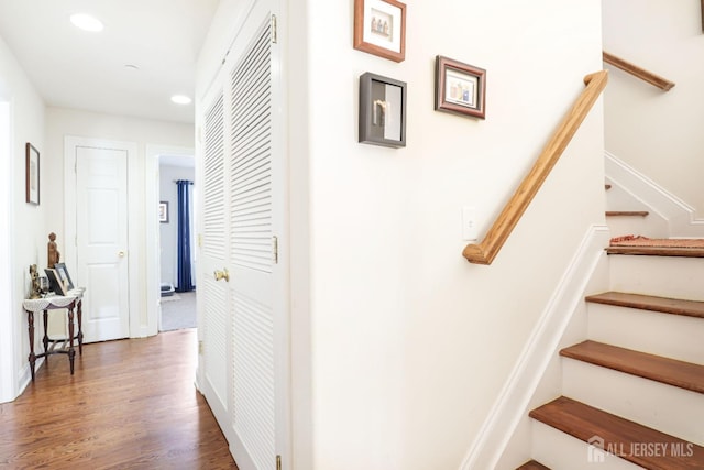 staircase with wood-type flooring