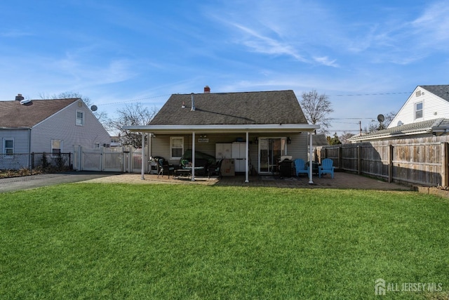 back of property featuring a patio area and a lawn