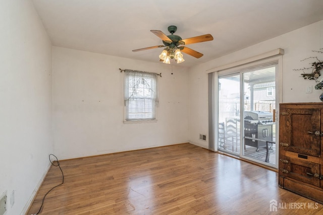 unfurnished room with ceiling fan and light hardwood / wood-style flooring