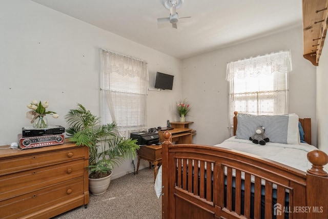 bedroom with ceiling fan and light colored carpet