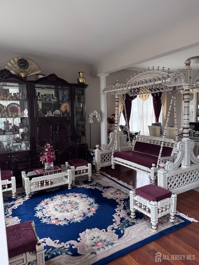 interior space with ornate columns and wood-type flooring