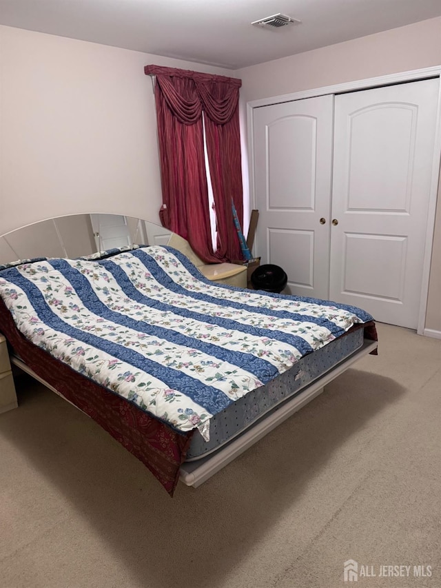 carpeted bedroom featuring a closet