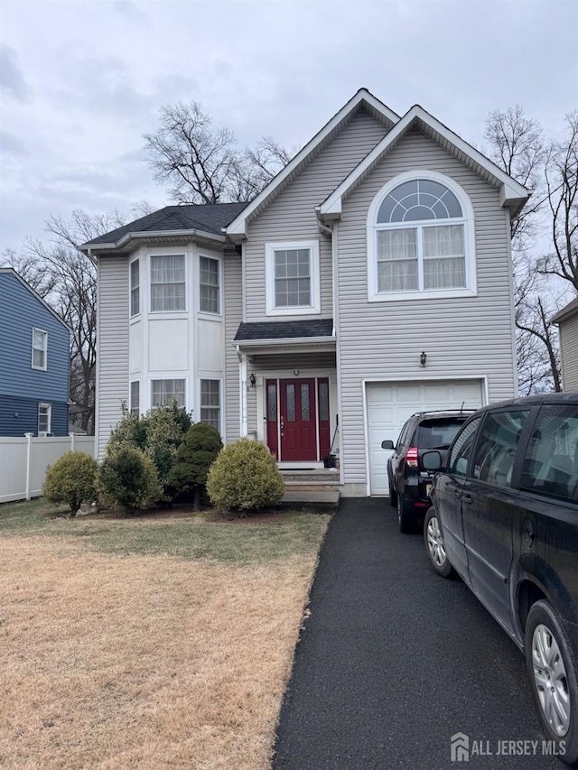 view of front of house featuring a front yard and a garage