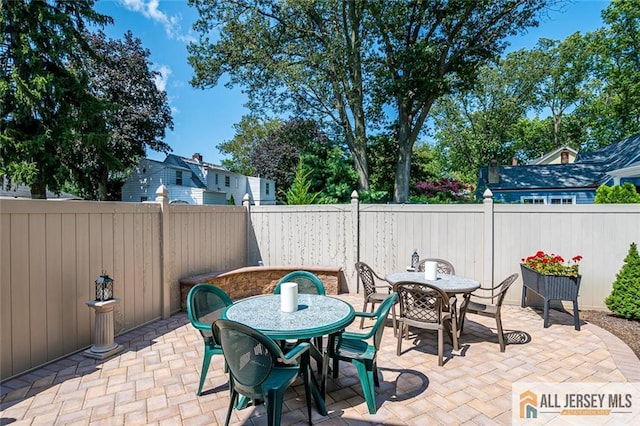view of patio featuring outdoor dining space and a fenced backyard