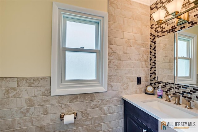 bathroom featuring tile walls, vanity, and tasteful backsplash