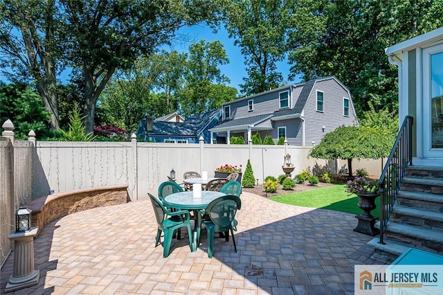 view of patio featuring outdoor dining area and a fenced backyard