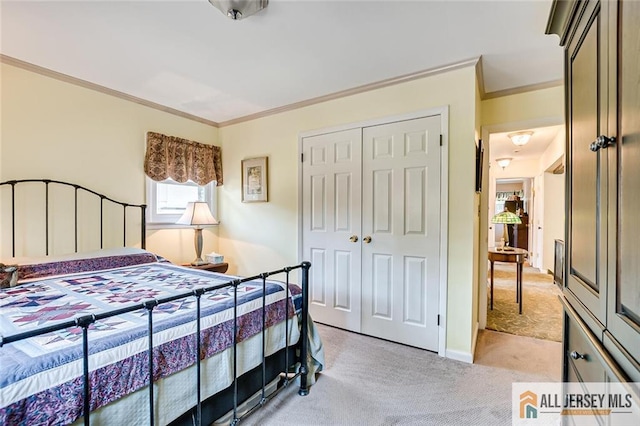 bedroom featuring light colored carpet, ornamental molding, and a closet