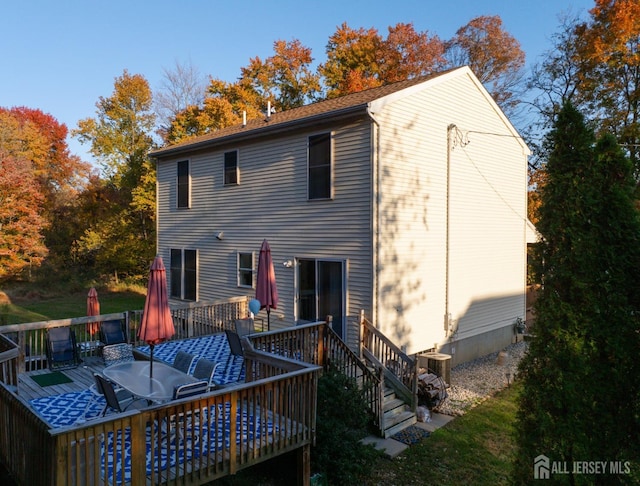 back of property featuring central AC and a deck