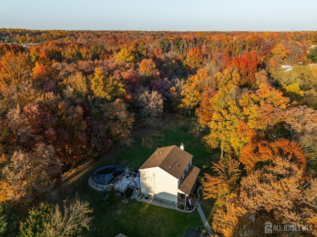 birds eye view of property with a wooded view