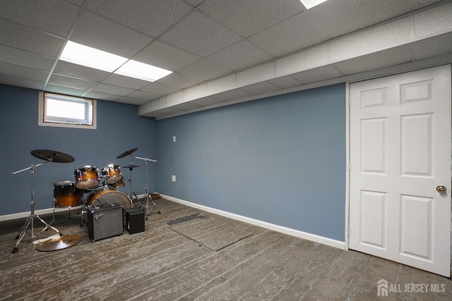 playroom with baseboards, wood finished floors, and a paneled ceiling
