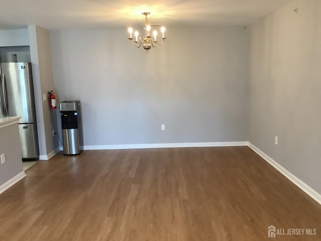 931 Cedar Ct, New Brunswick, NJ 08901 - unfurnished dining area with a chandelier and wood finished floors