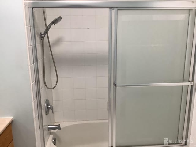931 Cedar Ct, New Brunswick, NJ 08901 - bathroom with vanity and combined bath / shower with glass door