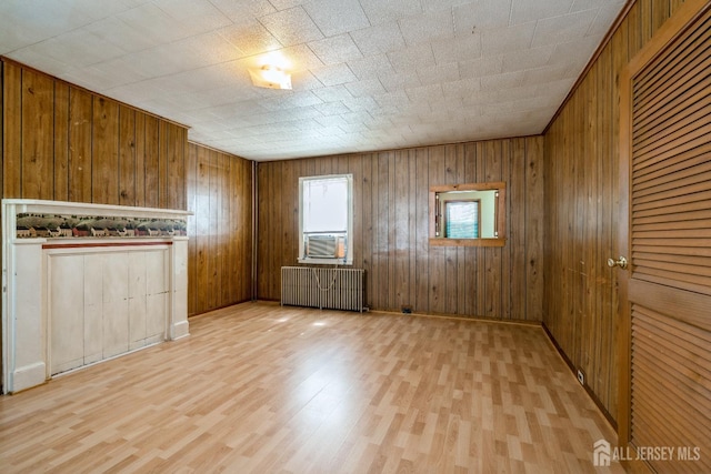 35 Kossman St, East Brunswick, NJ 08816 - spare room featuring radiator heating unit, wood finished floors, wooden walls, and cooling unit