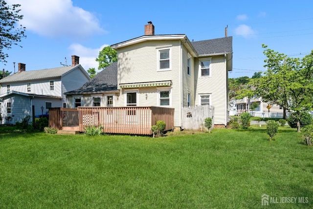 35 Kossman St, East Brunswick, NJ 08816 - back of property with a lawn, a deck, a chimney, and roof with shingles