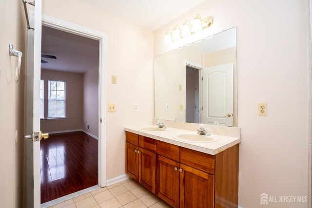 bathroom featuring ceiling fan, vanity, and tile patterned flooring