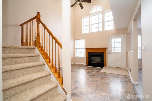 foyer featuring ceiling fan and a high ceiling