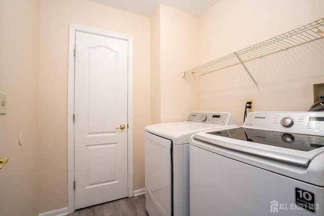 washroom featuring separate washer and dryer and light wood-type flooring