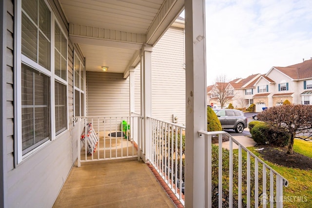 balcony with covered porch and a residential view