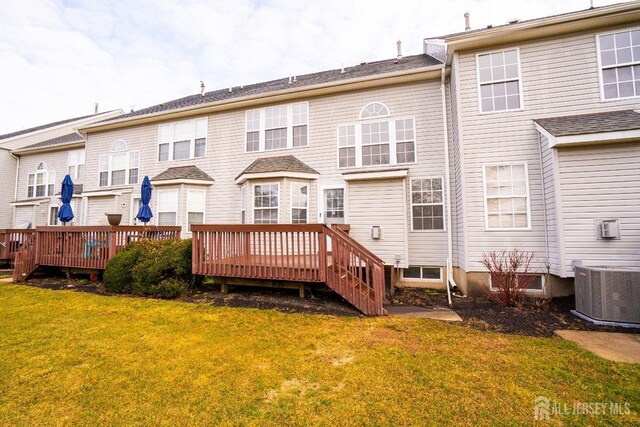 back of house with a wooden deck, a yard, and central air condition unit