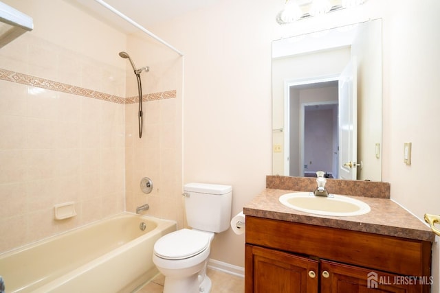 full bath featuring tile patterned flooring, toilet, vanity, and washtub / shower combination