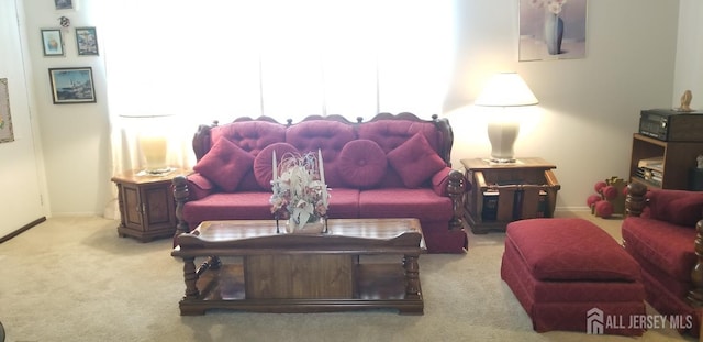 living area with baseboards and carpet flooring