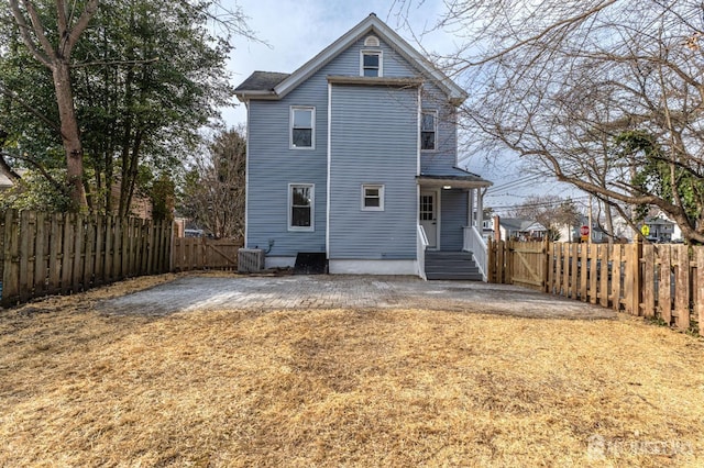 rear view of property with cooling unit