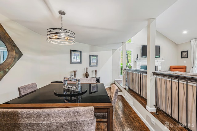 215 Kingsberry Dr, Franklin Twsp, NJ 08873 - dining space with wood finished floors, vaulted ceiling, a chandelier, and a fireplace