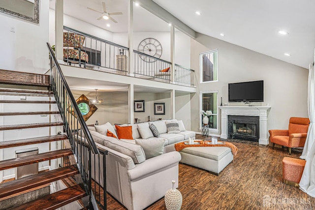 215 Kingsberry Dr, Franklin Twsp, NJ 08873 - living area featuring stairway, a fireplace with flush hearth, wood finished floors, high vaulted ceiling, and a ceiling fan
